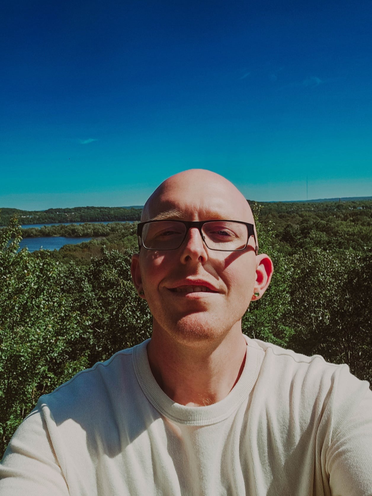 Chad, standing on a hill, overlooking trees